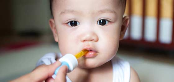 Decoding cough - infant being given medicine via dropper
