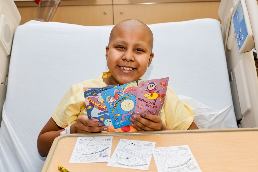 Smiling patient holding Valentine's cards