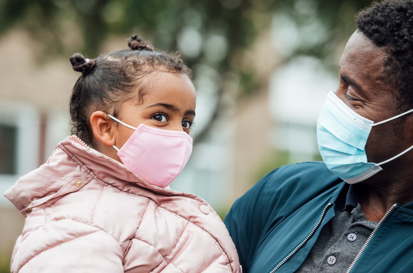 Father and daughter wearing masks