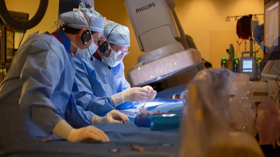 Doctor placing stent in cath lab