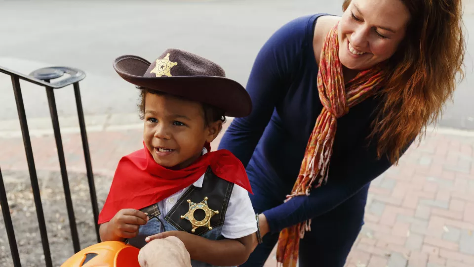Child trick or treating with Mom
