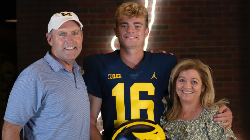 Davis in Michigan uniform with parents
