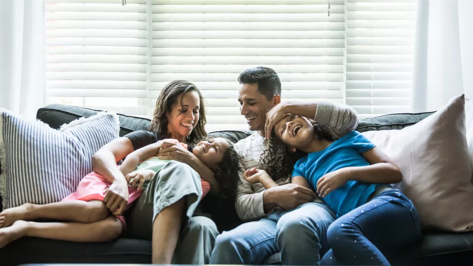 Family playing on couch