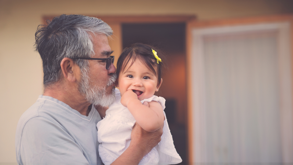 Grandfather holding granddaughter