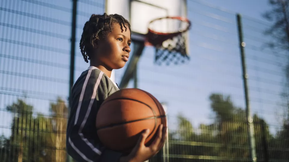 Photo of a child playing basketball