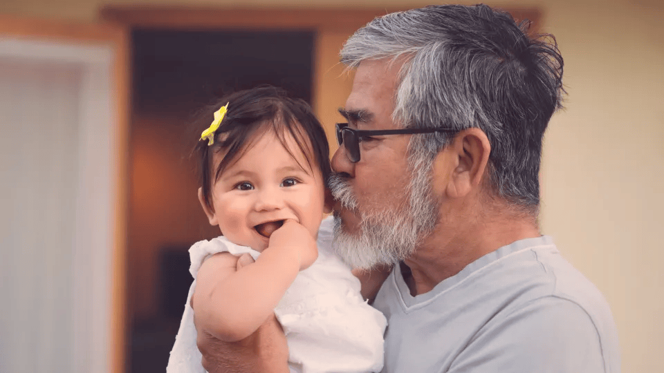 Grandfather kissing grandaughter on the cheek