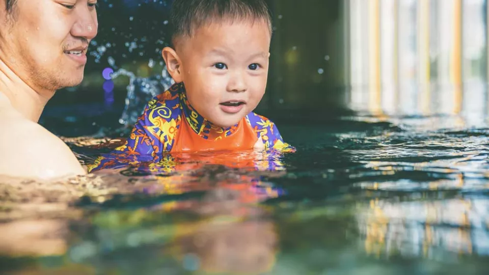 Toddler swimming in a pool