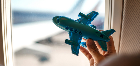 Toy airplane held by child