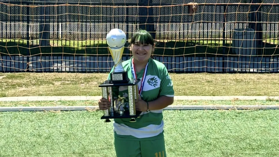 Ruby holding soccer trophy
