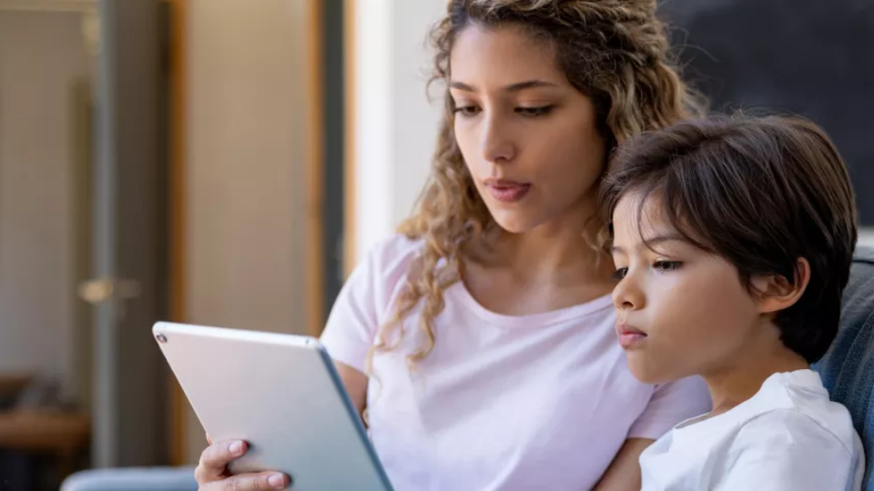 Mother and son looking at iPad