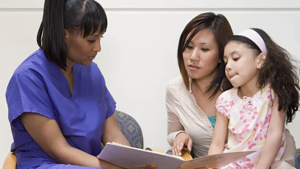 Doctor talking to mother and daughter